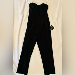 Black strapless romper with back zipper.